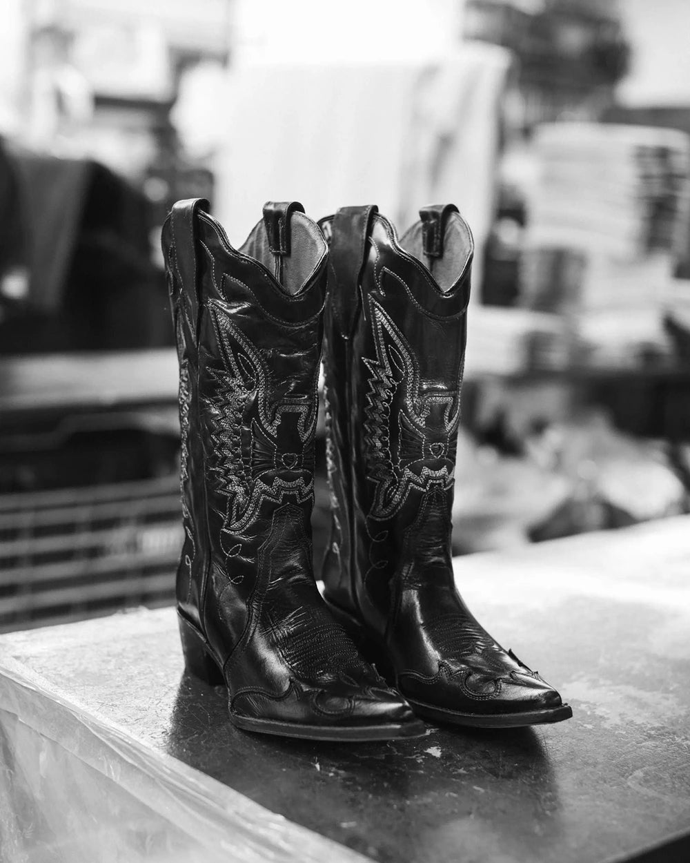 Pair of black cowboy boots with white embroidery, in black and white