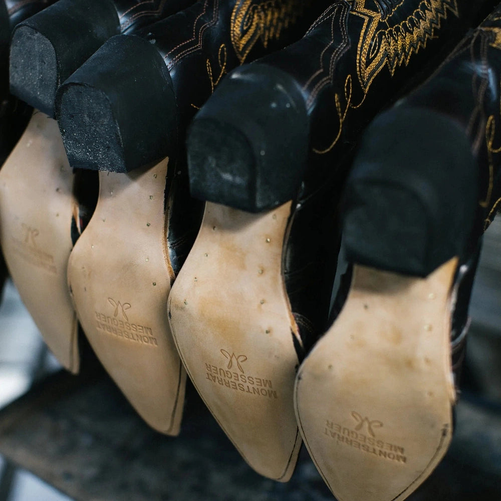 Leather soles of cowboy boots hanging in a row