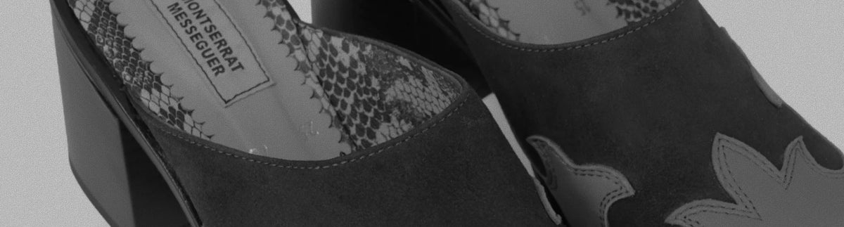Black suede mules with snakeskin lining and a Montserrat Messeguer label, in black and white