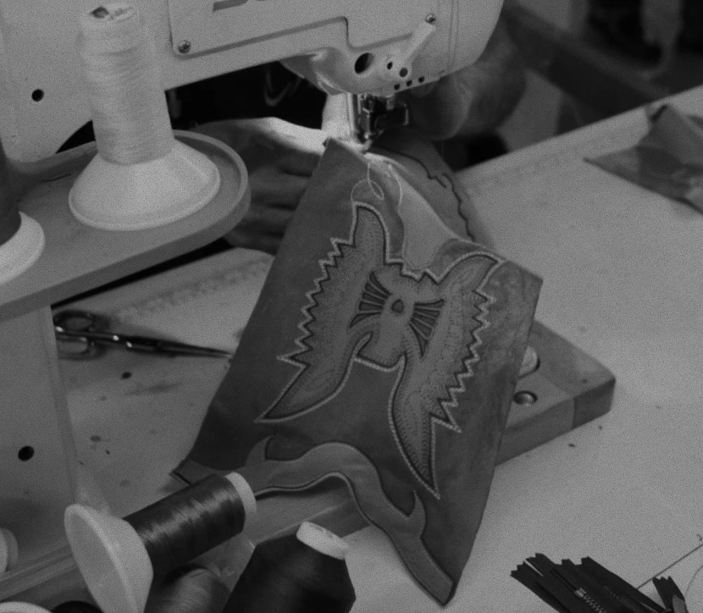 Caña de bota con el ave fénix bordado, en una máquina de coser, en blanco y negro
